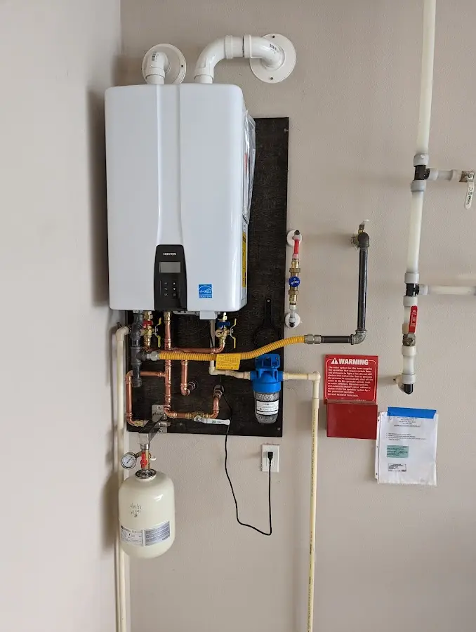 Professional plumber installing copper piping in a Ridge Manor home